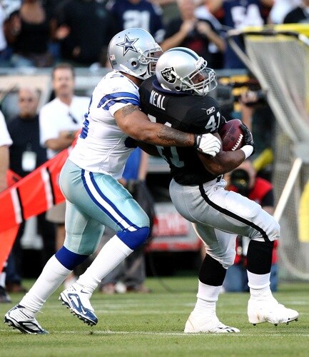 OAKLAND, CA - AUGUST 13:  Fullback Lorenzo Neal #41 of the Oakland Raiders is tackled by Anthony Spencer #93 of the Dallas Cowboys in the first quarter during the preseason game at Oakland-Alameda County Coliseum on August 13, 2009 in Oakland, California. <br /><br /><span class="help">(Photo by Jed Jacobsohn/Getty Images)</span>