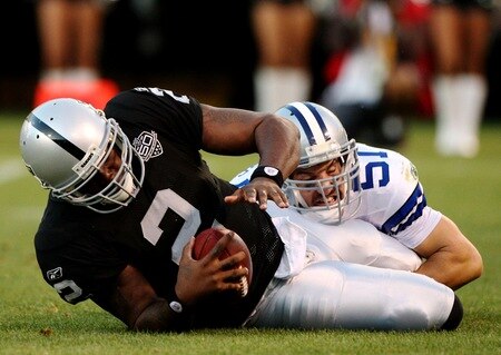 OAKLAND, CA - AUGUST 13:  Quarterback JaMarcus Russell #2 of the Oakland Raiders is sacked by Keith Brooking #51 of the Dallas Cowboys in the first quarter during the preseason game at Oakland-Alameda County Coliseum on August 13, 2009 in Oakland, California. <br /><br /><span class="help">(Photo by Jed Jacobsohn/Getty Images)</span>