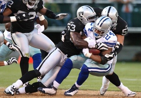 OAKLAND, CA - AUGUST 13:  Running back Marion Barber #24 of the Dallas Cowboys is tackled by Thomas Howard #53 and Ricky Brown #57 of the Oakland Raiders in the first quarter during the preseason game at Oakland-Alameda County Coliseum on August 13, 2009 in Oakland, California. <br /><br /><span class="help">(Photo by Jed Jacobsohn/Getty Images)</span>
