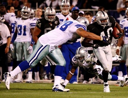 OAKLAND, CA - AUGUST 13:  Louis Rankin #40 of the Oakland Raiders runs the ball against Junior Siavii #78 of the Dallas Cowboys in the third quarter during the preseason game at Oakland-Alameda County Coliseum on August 13, 2009 in Oakland, California. <br /><br /><span class="help">(Photo by Jed Jacobsohn/Getty Images)</span>