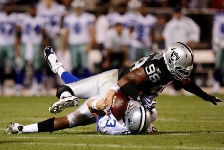 OAKLAND, CA - AUGUST 13:  Defensive end Jay Richardson #98 of the Oakland Raiders sacks quarterback Jon Kitna #3 of the Dallas Cowboys after a bad snap during the preseason game at Oakland-Alameda County Coliseum on August 13, 2009 in Oakland, California. <br /><br /><span class="help">(Photo by Jed Jacobsohn/Getty Images)</span>