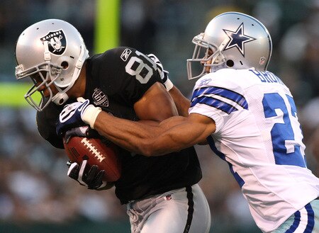 OAKLAND, CA - AUGUST 13: Chaz Schilens #81 of the Oakland Raiders catches a pass over Courtney Brown #27 of the Dallas Cowboys during a preseason game at Oakland-Alameda County Coliseum on August 13, 2009 in Oakland, California.  <br /><br /><span class="help">(Photo by Jed Jacobsohn/Getty Images)</span>