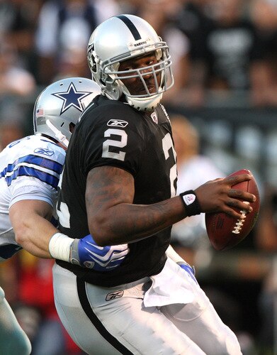 OAKLAND, CA - AUGUST 13: Quarterback JaMarcus Russell #2 of the Oakland Raiders is sacked by Keith Brooking #51 of the Dallas Cowboys in the first quarter during the preseason game at Oakland-Alameda County Coliseum on August 13, 2009 in Oakland, California. <br /><br /><span class="help">(Photo by Jed Jacobsohn/Getty Images)</span>