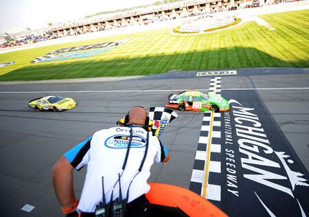 BROOKLYN, MI - AUGUST 15:  Brad Keselowski, driver of the #88 GoDaddy Chevrolet, takes the checkered flag as he crosses the start finish/line ahead of Brian Vickers, driver of the #32 Dollar General Stores Toyot, to win the NASCAR Nationwide Series at Michigan International Speedway on August 15, 2009 in Brooklyn, Michigan.  <br /><br /><span class="help">(Photo by Harry How/Getty Images)</span>