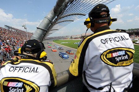 BROOKLYN, MI - AUGUST 16:  Kurt Busch, driver of the #2 Miller Lite Dodge, leads a pack of cars as they drive towards two NASCAR officials who keep watch from the starter's stand during the NASCAR Sprint Cup Series CARFAX 400 at Michigan International Speedway on August 16, 2009 in Brooklyn, Michigan.  <br /><br /><span class="help">(Photo by Harry How/Getty Images)</span>