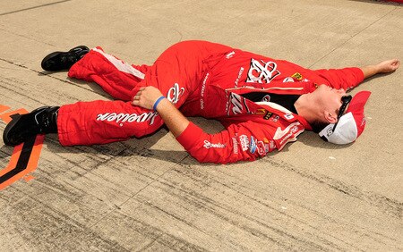 BROOKLYN, MI - AUGUST 16:  A crew member of the #9 Budweiser Dodge driven by Kasey Kahne, stretches on the grid during the NASCAR Sprint Cup Series CARFAX 400 at Michigan International Speedway on August 16, 2009 in Brooklyn, Michigan.  <br /><br /><span class="help">(Photo by Rusty Jarrett/Getty Images for NASCAR)</span>