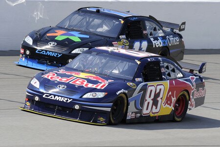 BROOKLYN, MI - AUGUST 16:  Brian Vickers, driver of the #83 Red Bull Toyota, leads Denny Hamlin, driver of the #11 FedEx Office Toyota, during the NASCAR Sprint Cup Series CARFAX 400 at Michigan International Speedway on August 16, 2009 in Brooklyn, Michigan.  <br /><br /><span class="help">(Photo by John Harrelson/Getty Images for NASCAR)</span>