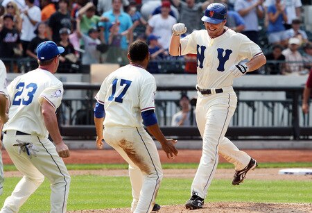 NEW YORK - AUGUST 16:  Daniel Murphy #28 of the New York Mets celebrates his game winning hit against the San Francisco Giants with teammates Fernando Tatis #17 and Brian Schneider #23 on August 16, 2009 at Citi Field in the Flushing neighborhood of the Queens borough of New York City.  <br /><br /><span class="help">(Photo by Jim McIsaac/Getty Images)</span>