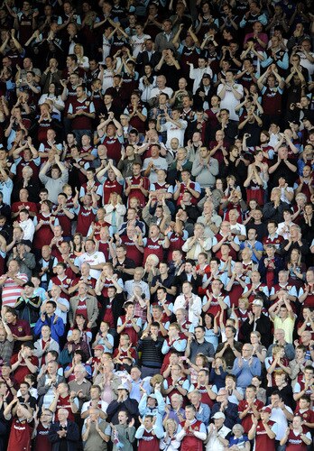 BURNLEY, ENGLAND - AUGUST 19:   Burnley fans celebrate during the Barclays Premier League match between Burnley and Manchester United at Turf Moor on August 19, 2009 in Burnley, England.  <br /><br /><span class="help">(Photoby Laurence Griffiths/Getty Images)</span>