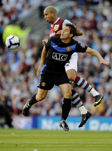 BURNLEY, ENGLAND - AUGUST 19:  Tyrone Mears of Burnley and Michael Owen of Manchester United go for the header during the Barclays Premier League match between Burnley and Manchester United at Turf Moor on August 19, 2009 in Burnley, England.  <br /><br /><span class="help">(Photoby Laurence Griffiths/Getty Images)</span>