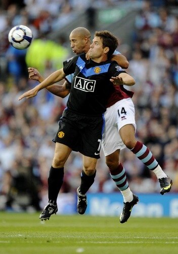 BURNLEY, ENGLAND - AUGUST 19:  Tyrone Mears of Burnley and Michael Owen of Manchester United go for the header during the Barclays Premier League match between Burnley and Manchester United at Turf Moor on August 19, 2009 in Burnley, England.  <br /><br /><span class="help">(Photoby Laurence Griffiths/Getty Images)</span>