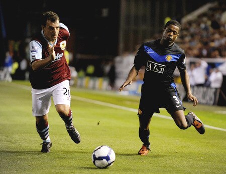 BURNLEY, ENGLAND - AUGUST 19:  Robbie Blake of Burnley battles for the ball with Patrice Evra of Manchester United during the Barclays Premier League match between Burnley and Manchester United at Turf Moor on August 19, 2009 in Burnley, England.  <br /><br /><span class="help">(Photoby Laurence Griffiths/Getty Images)</span>