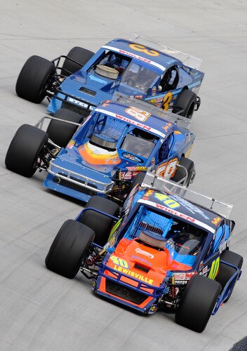 BRISTOL, TN - AUGUST 19:  Frank Fleming driver of the #40 Nelson Ford/Pro Health Centers Ford races with Johnny Bush driver of the #68 J.B. Stone Setters/Mehner Racing Chevrolet and Ryan Preece driver of the #3 Reynolds Auto Wrecking Chevrolet duirng the NASCAR Whelen Modified Tour at Bristol Motor Speedway on August 19, 2009 in Bristol, Tennessee.  <br /><br /><span class="help">(Photo by John Harrelson/Getty Images for NASCAR)</span>