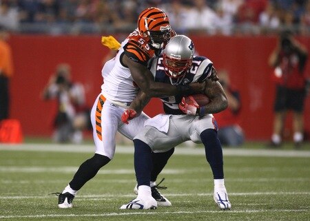 FOXBORO, MA - AUGUST 20:  Fred Taylor #21 of the New England Patriots runs the ball against Keith Rivers #55 of the Cincinnati Bengals during their preseason game at Gillette Stadium on August 20, 2009 in Foxboro, Massachusetts. A flag is thrown by a referee on the play. <br /><br /><span class="help">(Photo by Jim Rogash/Getty Images)</span>
