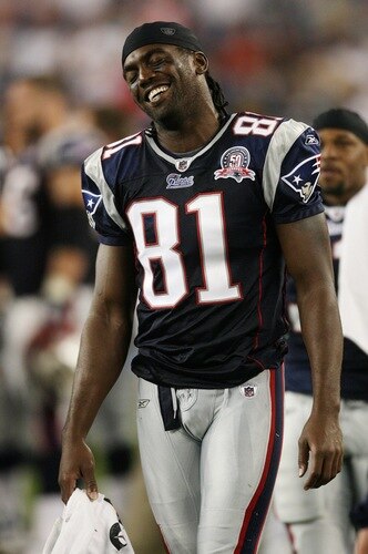 FOXBORO, MA - AUGUST 20:  Randy Moss #81 of the New England Patriots smiles on the sideline against the Cincinnati Bengals during their preseason game at Gillette Stadium on August 20, 2009 in Foxboro, Massachusetts.  <br /><br /><span class="help">(Photo by Jim Rogash/Getty Images)</span>