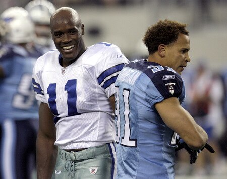 ARLINGTON, TX - AUGUST 21:  Wide receiver Roy Williams #11 of the Dallas Cowboys (left) reacts after losing his helmet on a play the first quarter against corner back Cortland Finnegan #31 ofthe Tennessee Titans during a preseason game at Cowboys Stadium on August 21, 2009 in Arlington, Texas. <br /><br /><span class="help">(Photo by Tom Pennington/Getty Images)</span>