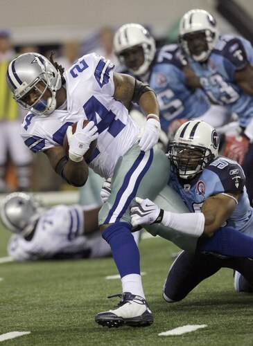 ARLINGTON, TX - AUGUST 21:  Running back Marion Barber #24 of the Dallas Cowboys carries the ball in the first quarter against line backer David Thornton #50 of the Tennessee Titans during a preseason game at Cowboys Stadium on August 21, 2009 in Arlington, Texas. <br /><br /><span class="help">(Photo by Tom Pennington/Getty Images)</span>