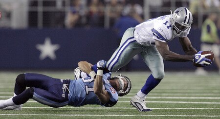 ARLINGTON, TX - AUGUST 21:  Wide receiver Roy Williams #11 of the Dallas Cowboys carries the ball in the first quarter against corner back Cortland Finnegan #31of the Tennessee Titans during a preseason game at Cowboys Stadium on August 21, 2009 in Arlington, Texas. <br /><br /><span class="help">(Photo by Tom Pennington/Getty Images)</span>