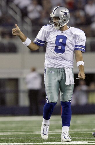 ARLINGTON, TX - AUGUST 21:  Quarterback Tony Romo #9 of the Dallas Cowboys reacts in the first quarter after the Tennessee Titans were charged with pass interferance during a preseason game at Cowboys Stadium on August 21, 2009 in Arlington, Texas.  The Cowboys went on to score against the Titans on the drive. <br /><br /><span class="help">(Photo by Tom Pennington/Getty Images)</span>