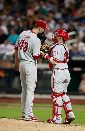 NEW YORK - AUGUST 22: J.A. Happ #43 and Carlos Ruiz #51 visit at the mound in between innings against the New York Mets during the game on August 22, 2009 at Citi Field in the Flushing neighborhood of the Queens borough of New York City.  <br /><br /><span class="help">(Photo by Jared Wickerham/Getty Images)</span>