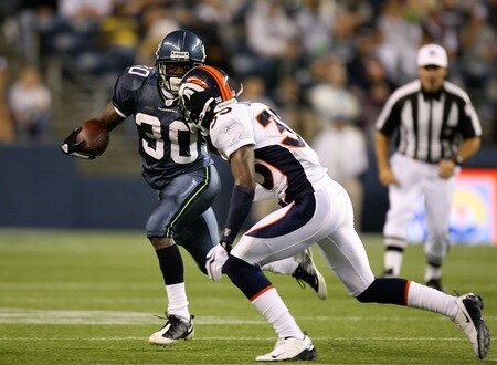SEATTLE - AUGUST 22:  Running back Devin Moore #30 of the Seattle Seahawks rushes against D.J. Johnson #35 of the Denver Broncos on August 22, 2009 at Qwest Field in Seattle, Washington. The Seahawks defeated the Broncos 27-13. <br /><br /><span class="help">(Photo by Otto Greule Jr/Getty Images)</span>