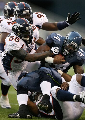 SEATTLE - AUGUST 22:  Running back T.J. Duckett #44 of the Seattle Seahawks rushes against D.J. Williams #55 of the Denver Broncos on August 22, 2009 at Qwest Field in Seattle, Washington. The Seahawks defeated the Broncos 27-13. <br /><br /><span class="help">(Photo by Otto Greule Jr/Getty Images)</span>