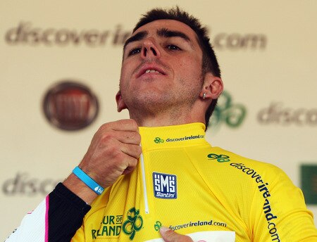 CORK, IRELAND - AUGUST 23:  Russell Downing of Great Britain and Candi TV pulls on the yellow jersey after winning the 2009 Tour of Ireland Stage Three from Bantry to Cork on August 23, 2009 in Cork, Ireland.  <br /><br /><span class="help">(Photo by Bryn Lennon/Getty Images).</span>