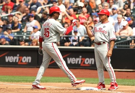 NEW YORK - AUGUST 23:  Pedro Martinez #45 of the Philadelphia Phillies celebrates with first base coach Davey Lopes #15 after Martinez hit a RBI-single in the top of the third inning against the New York Mets on August 23, 2009 at Citi Field in the Flushing neighborhood of the Queens borough of New York City.  <br /><br /><span class="help">(Photo by Al Bello/Getty Images)</span>