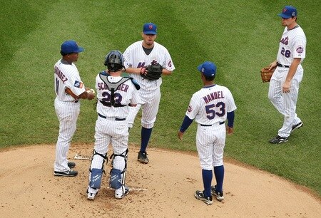 NEW YORK - AUGUST 23:  Manager Jerry Manuel of the New York Mets walks out to the mound to take starting pitcher Oliver Perez #46 out of the game in the top of the first inning as Anderson Hernandez #11 (L), Brian Schneider #23 and Daniel Murphy #38 of the Mets look on against the Philadelphia Phillies on August 23, 2009 at Citi Field in the Flushing neighborhood of the Queens borough of New York City.  <br /><br /><span class="help">(Photo by Al Bello/Getty Images)</span>