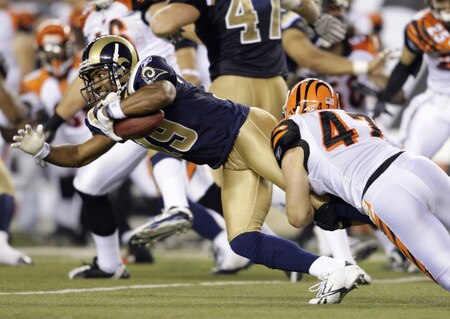 CINCINNATI, OH - AUGUST 27:  Wide receiver Ronald Curry #89 of the St. Louis Rams is tackled by Corey Lynch #47 of the Cincinnati Bengals during the preseason game at Paul Brown Stadium on August 27, 2009 in Cincinnati, Ohio. <br /><br /><span class="help">(Photo by Andy Lyons/Getty Images)</span>