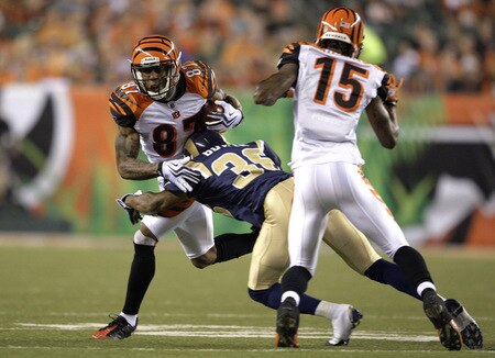 CINCINNATI, OH - AUGUST 27:  Wide receiver Andre Caldwell #87 of the Cincinnati Bengals attempts to break the tackle of Quincy Butler #36 of the St. Louis Rams during the preseason game at Paul Brown Stadium on August 27, 2009 in Cincinnati, Ohio. <br /><br /><span class="help">(Photo by Andy Lyons/Getty Images)</span>