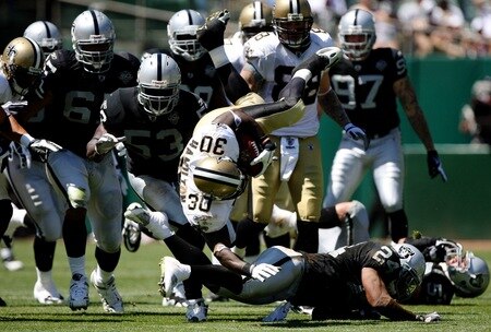 OAKLAND, CA - AUGUST 29:  Running back Lynell Hamilton #30 of the New Orleans Saints is tackled by Michael Huff #24 of the Oakland Raiders during the preseason game at Oakland-Alameda County Coliseum on August 29, 2009 in Oakland, California. <br /><br /><span class="help">(Photo by Jed Jacobsohn/Getty Images)</span>