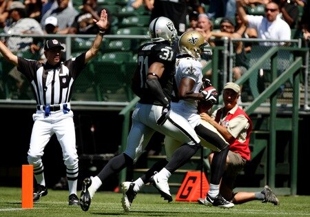 OAKLAND, CA - AUGUST 29:  Wide receiver Devery Henderson #19 of the New Orleans Saints runs in for a touchdown as Hiram Eugene #31 of the Oakland Raiders gives chase during the preseason game at Oakland-Alameda County Coliseum on August 29, 2009 in Oakland, California. <br /><br /><span class="help">(Photo by Jed Jacobsohn/Getty Images)</span>