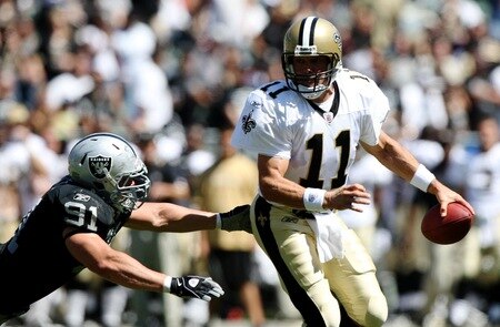 OAKLAND, CA - AUGUST 29:  Quarterback Mark Brunell #11 of the New Orleans Saints rolls out to pass against Trevor Scott #91 of the Oakland Raiders during the preseason game at Oakland-Alameda County Coliseum on August 29, 2009 in Oakland, California. <br /><br /><span class="help">(Photo by Jed Jacobsohn/Getty Images)</span>