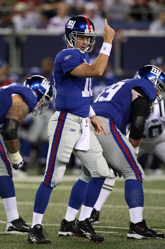 EAST RUTHERFORD, NJ - AUGUST 29:  Quarterback Eli Manning #10 of the New York Giants calls a play at the line of scrimmage in the first quarter of a preseason game against the New York Jets at Giants Stadium on August 29, 2009 in East Rutherford, New Jersey.  <br /><br /><span class="help">(Photo by Jim McIsaac/Getty Images)</span>