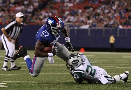 EAST RUTHERFORD, NJ - AUGUST 29:  Running back Brandon Jacobs #27 of the New York Giants gets tackled by corner back Darrelle Revis #27 of the New York Jets during the preseason game at Giants Stadium on August 29, 2009 in East Rutherford, New Jersey.  <br /><br /><span class="help">(Photo by Jim McIsaac/Getty Images)</span>