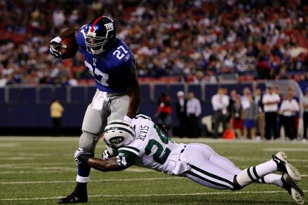 EAST RUTHERFORD, NJ - AUGUST 29:  Running back Brandon Jacobs #27 of the New York Giants tires to get by a tackle by corner back Darrelle Revis #27 of the New York Jets during the preseason game at Giants Stadium on August 29, 2009 in East Rutherford, New Jersey.  <br /><br /><span class="help">(Photo by Jim McIsaac/Getty Images)</span>