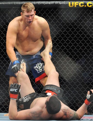 PORTLAND, OR - AUGUST 29:  UFC fighter Mike Russow (L) battles UFC fighter Justin McCully (R) during their Heavyweight bout at UFC 102:  Couture vs. Nogueira at the Rose Garden Arena on August 29, 2009 in Portland, Oregon.  <br /><br /><span class="help">(Photo by Jon Kopaloff/Getty Images)</span>