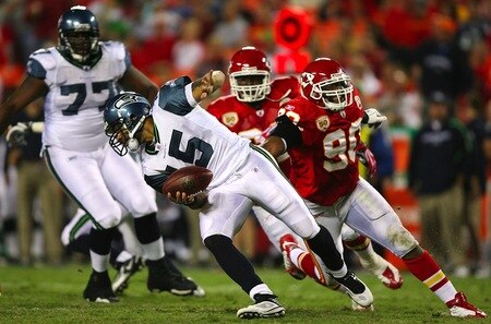 KANSAS CITY, MO - AUGUST 29: Quarterback Seneca Wallace #15 of the Seattle Seahawks scrammbles as he is pressured by Turk McBride #90 of the Kansas City Chiefs during their preseason game at Arrowhead Stadium on August 29, 2009 in Kansas City, Missouri. <br /><br /><span class="help">(Photo by Dilip Vishwanat/Getty Images)</span>