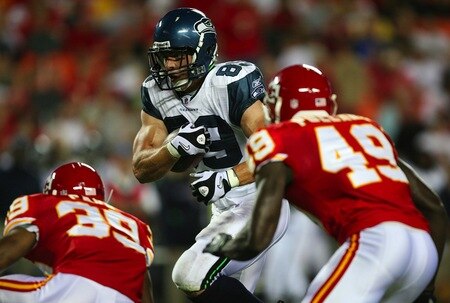 KANSAS CITY, MO - AUGUST 29: John Carlson #89 of the Seattle Seahawks runs for yards after the catch against Brandon Carr #39 and Bernard Pollard #49 of the Kansas City Chiefs during their preseason game at Arrowhead Stadium on August 29, 2009 in Kansas City, Missouri. <br /><br /><span class="help">(Photo by Dilip Vishwanat/Getty Images)</span>