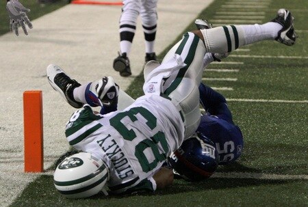 EAST RUTHERFORD, NJ - AUGUST 29:  Chansi Stuckey #83 of the New York Jets falls in the end zone for a touch down against linebacker Danny Clark #55 of the New York Giants during the preseason game at Giants Stadium on August 29, 2009 in East Rutherford, New Jersey.  <br /><br /><span class="help">(Photo by Jim McIsaac/Getty Images)</span>