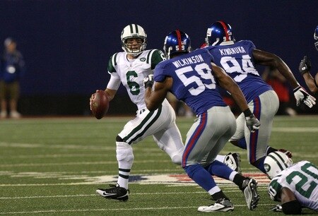 EAST RUTHERFORD, NJ - AUGUST 29:  Quarterback Mark Sanchez #6 of the New York Jets looks to throw the ball down field while under pressure from Gerris Wilkinson #59 and Mathias Kiwanuka #94 of the New York Giants during a preseason game at Giants Stadium on August 29, 2009 in East Rutherford, New Jersey.  <br /><br /><span class="help">(Photo by Jim McIsaac/Getty Images)</span>
