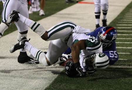 EAST RUTHERFORD, NJ - AUGUST 29:  Chansi Stuckey #83 of the New York Jets falls in the end zone for a touch down against linebacker Danny Clark #55 of the New York Giants during the preseason game at Giants Stadium on August 29, 2009 in East Rutherford, New Jersey.  <br /><br /><span class="help">(Photo by Jim McIsaac/Getty Images)</span>