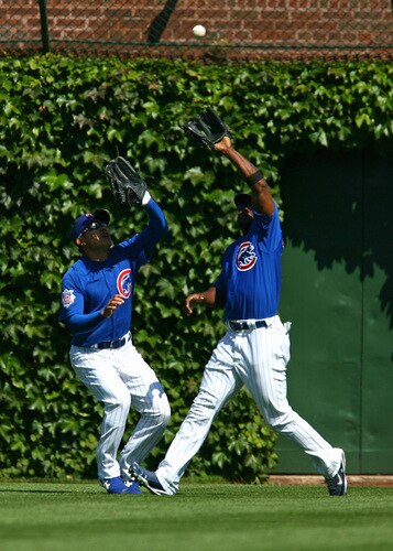CHICAGO - AUGUST 30: Milton Bradley #21 and Kosuke Fukudome #1 of the Chicago Cubs avoid a collision as Bradley makes the catch against the New York Mets on August 30, 2009 at Wrigley Field in Chicago, Illinois. <br /><br /><span class="help">(Photo by Jonathan Daniel/Getty Images)</span>