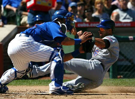 CHICAGO - AUGUST 30: Angel Pagan #16 of the New York Mets scores a run ahead of the throw to Geovaney Soto #18 of the Chicago Cubs on August 30, 2009 at Wrigley Field in Chicago, Illinois. <br /><br /><span class="help">(Photo by Jonathan Daniel/Getty Images)</span>