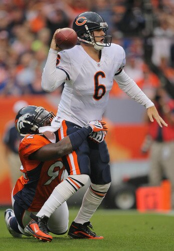 DENVER - AUGUST 30:  Quarterback Jay Cutler #6 of the Chicago Bears looks to get rid of the ball while under pressure from Elvis Dumervil #92 of the Denver Broncos during the first quarter at INVESCO Field at Mile High on August 30, 2009 in Denver, Colorado.  <br /><br /><span class="help">(Photo by Doug Pensinger/Getty Images)</span>