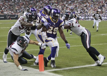 HOUSTON - AUGUST 31:  Running back Chester Taylor #29 of the Minnesota Vikings crosses the goal line for a score at the end of the second quarter before linebacker DeMeco Ryans #59 and safety Dominque Barber #34 can make the tackle at Reliant Stadium on August 31, 2009 in Houston, Texas.  <br /><br /><span class="help">(Photo by Bob Levey/Getty Images)</span>