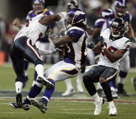 HOUSTON - AUGUST 31:  Wide receiver  Sidney Rice #18 of the Minnesota Vikings takes a hard hit from cornerback Brice McCain of Houston Texans ,left, at Reliant Stadium on August 31, 2009 in Houston, Texas.  <br /><br /><span class="help">(Photo by Bob Levey/Getty Images)</span>