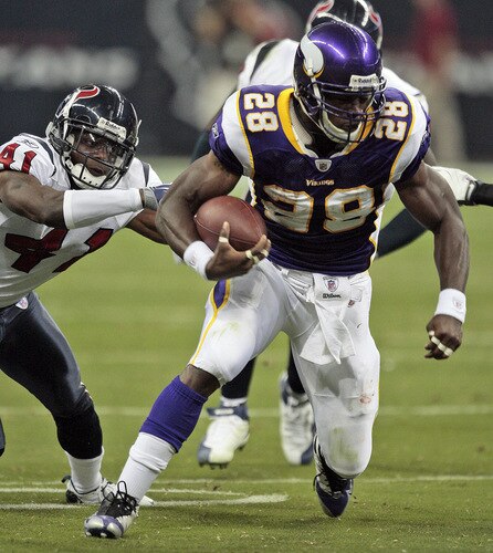 HOUSTON - AUGUST 31:  Running back Adrian Peterson #28 of the Minnesota Vikings breaks a tackle by cornerback Brice McCain #41 of the Houston Texans at Reliant Stadium on August 31, 2009 in Houston, Texas.  <br /><br /><span class="help">(Photo by Bob Levey/Getty Images)</span>