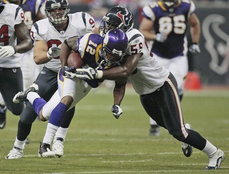 HOUSTON - AUGUST 31:  Wide receiver  Percy Harvin #12 of the Minnesota Vikings is tackled by linebacker DeMeco Ryans #59 of the Houston Texans at Reliant Stadium on August 31, 2009 in Houston, Texas.  <br /><br /><span class="help">(Photo by Bob Levey/Getty Images)</span>